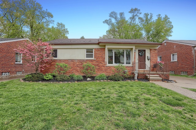 ranch-style house featuring brick siding and a front lawn