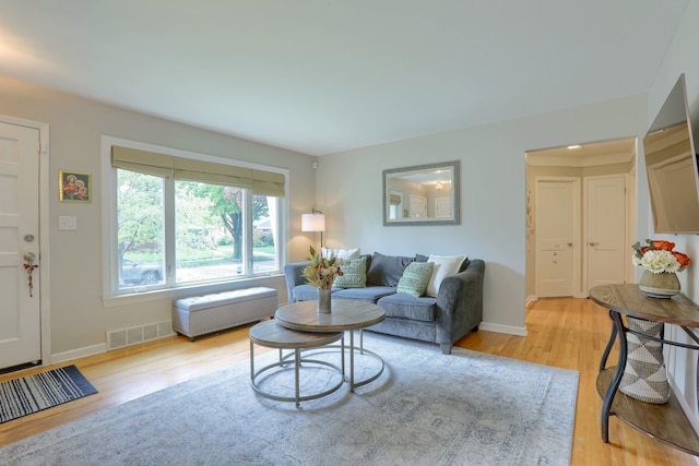 living area featuring light wood-type flooring and baseboards