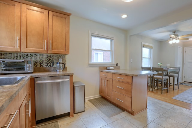 kitchen with dishwasher, decorative backsplash, ceiling fan, brown cabinets, and recessed lighting
