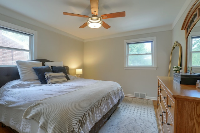 bedroom featuring baseboards, ceiling fan, and wood finished floors