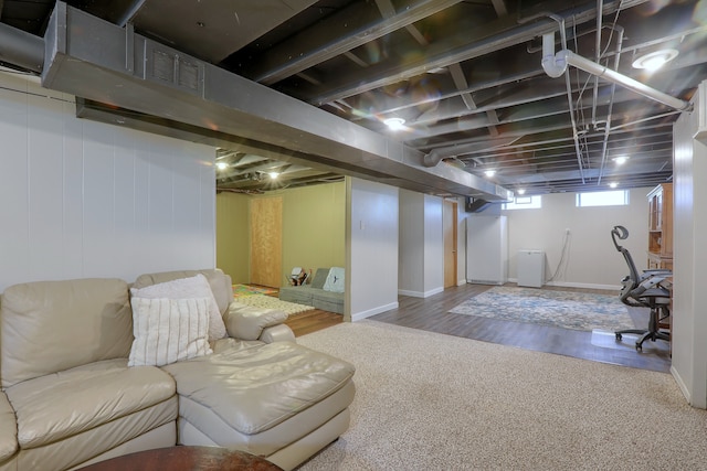 basement with carpet flooring and wood finished floors