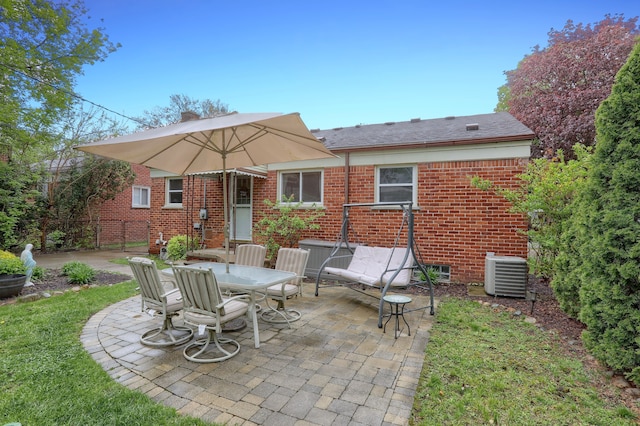 back of property with a patio area, central AC, brick siding, and fence