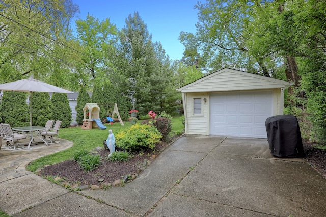 detached garage with concrete driveway