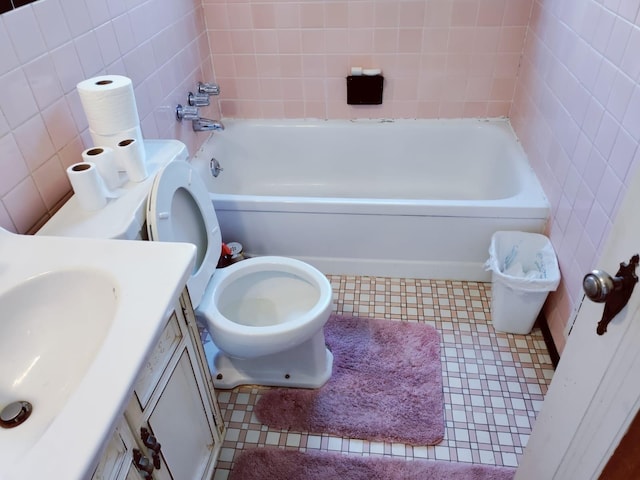 full bathroom with tile patterned floors, vanity, toilet, and tile walls