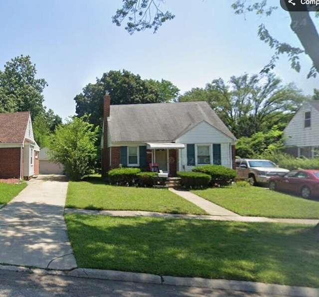 view of front of home with a front lawn and concrete driveway