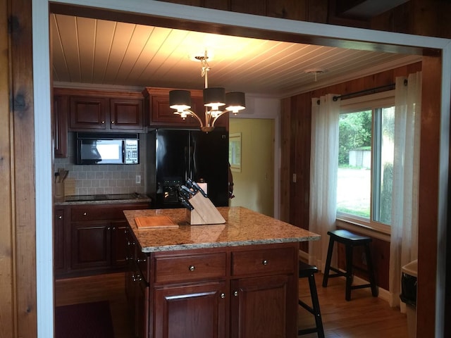 kitchen featuring a kitchen island, wood ceiling, decorative backsplash, a notable chandelier, and black appliances