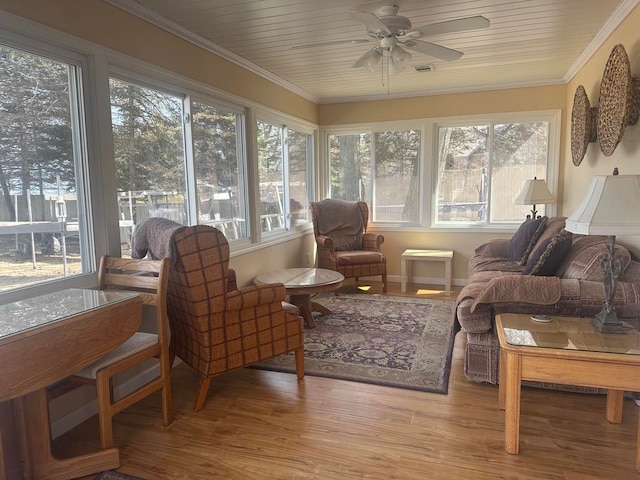 sunroom with a wealth of natural light, wood ceiling, and ceiling fan