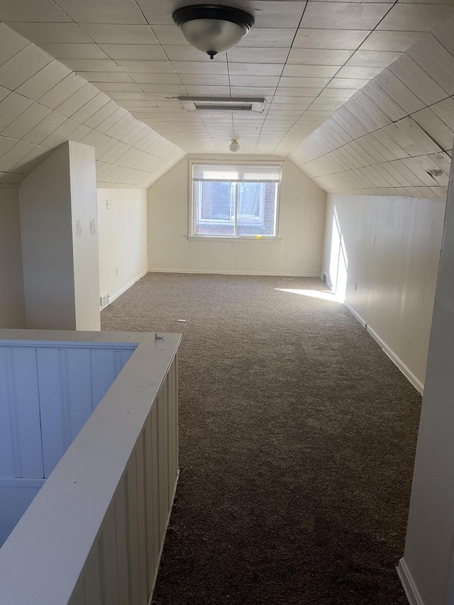 bonus room with lofted ceiling, visible vents, baseboards, and carpet floors