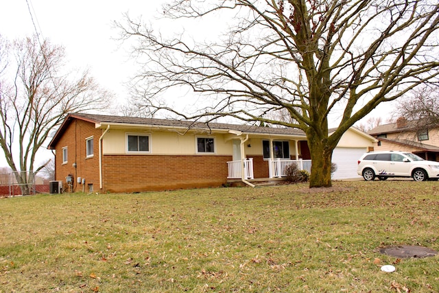 ranch-style house featuring brick siding, a garage, covered porch, and a front yard
