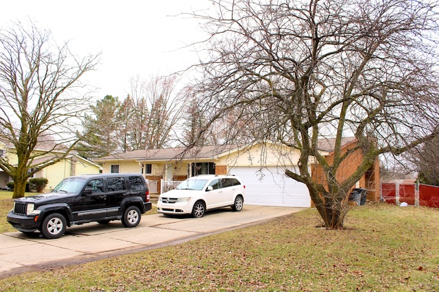 ranch-style house with concrete driveway, a garage, and a front yard