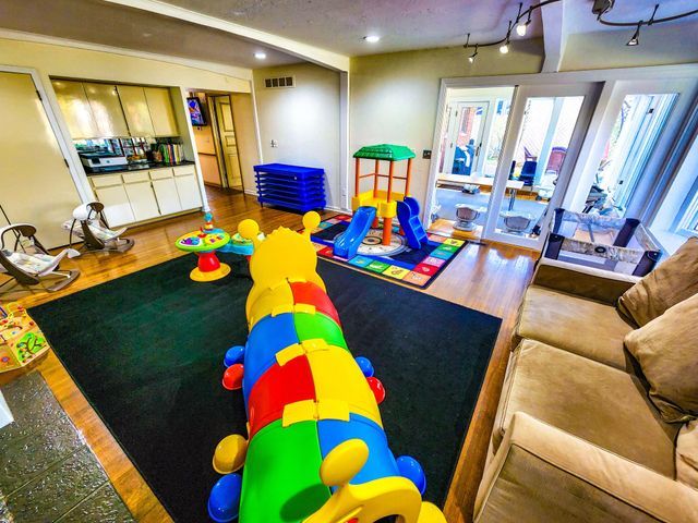 recreation room featuring wood finished floors and visible vents