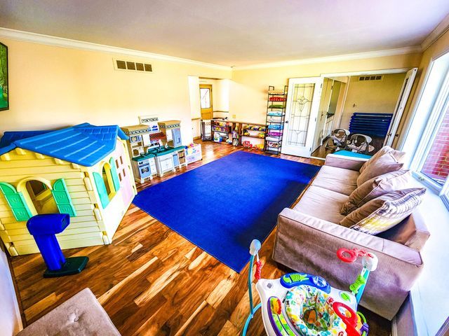 rec room featuring crown molding and visible vents