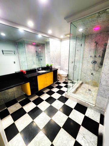 bathroom featuring recessed lighting, vanity, a stall shower, and toilet
