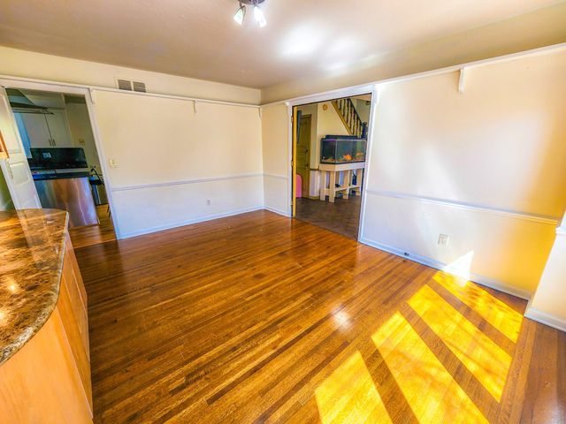 unfurnished room featuring visible vents and wood finished floors