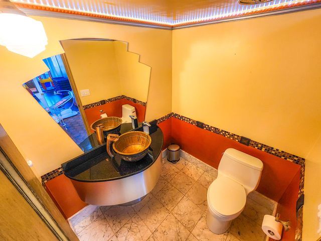 bathroom featuring a wainscoted wall and toilet