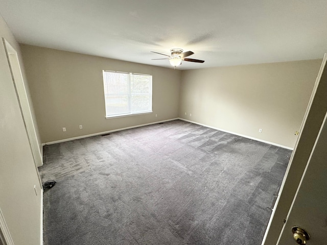 unfurnished bedroom featuring visible vents, baseboards, carpet, and a ceiling fan