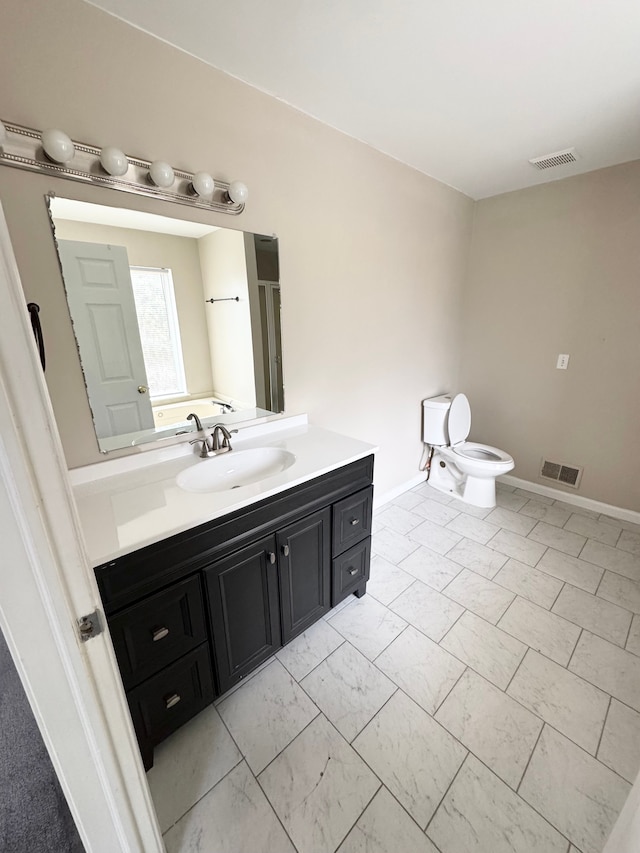 bathroom with vanity, toilet, visible vents, and marble finish floor