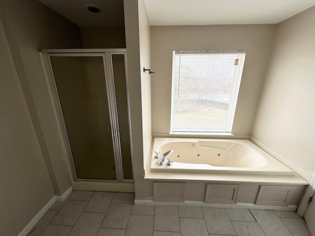 bathroom featuring a shower stall and a whirlpool tub