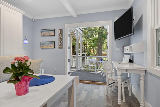 dining space featuring light wood finished floors, beamed ceiling, and crown molding