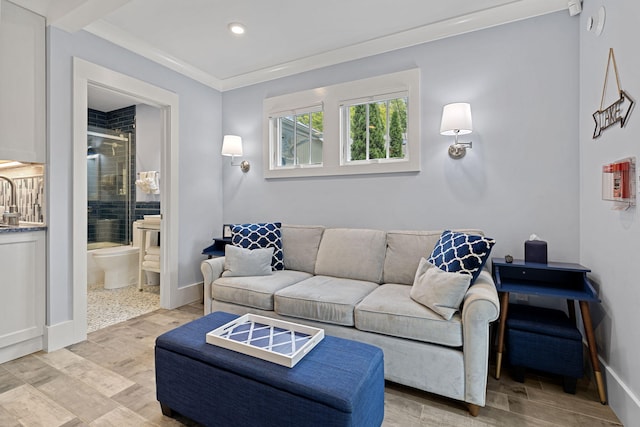 living area with recessed lighting, baseboards, light wood-style floors, and crown molding