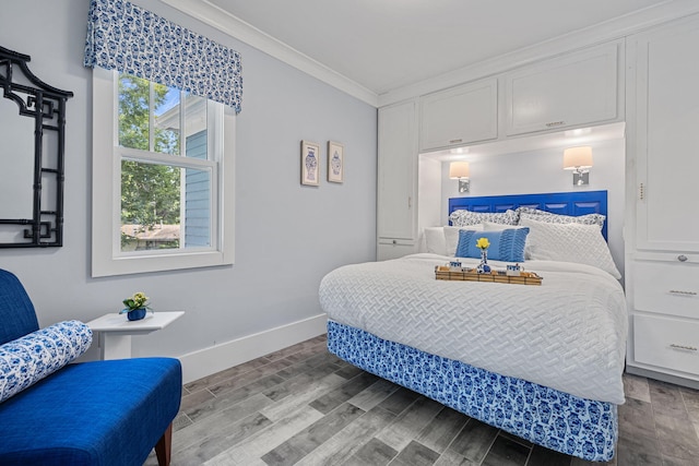 bedroom with crown molding, baseboards, and wood finished floors