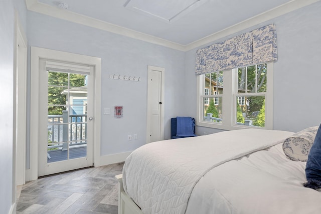 bedroom featuring crown molding, access to outside, attic access, and baseboards