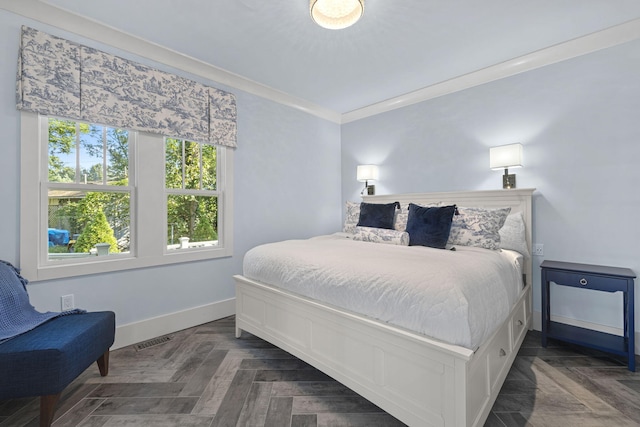 bedroom with visible vents, baseboards, and ornamental molding