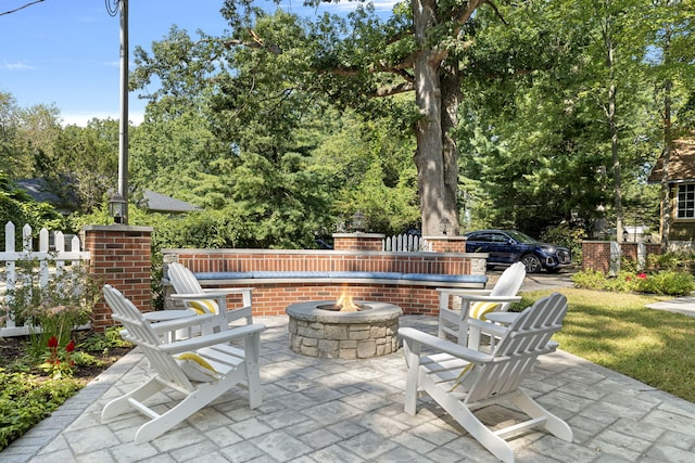 view of patio / terrace with fence and an outdoor fire pit