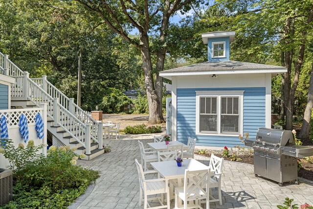 view of patio / terrace with outdoor dining space, stairway, and area for grilling
