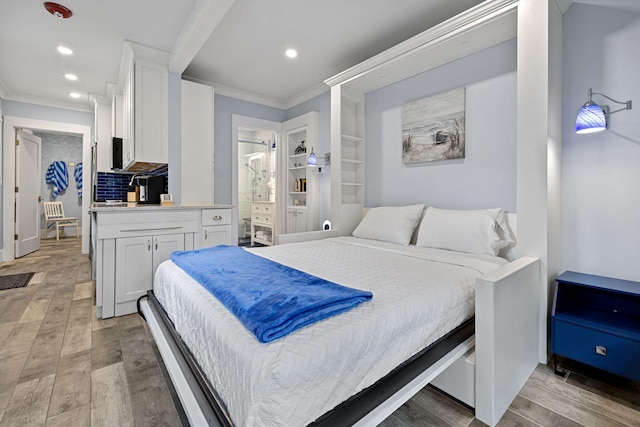 bedroom with recessed lighting, light wood-style floors, ensuite bathroom, and ornamental molding