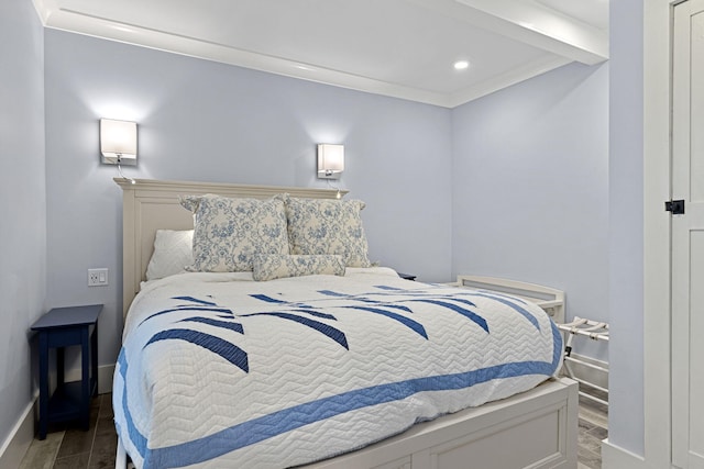 bedroom featuring baseboards, wood finish floors, and ornamental molding