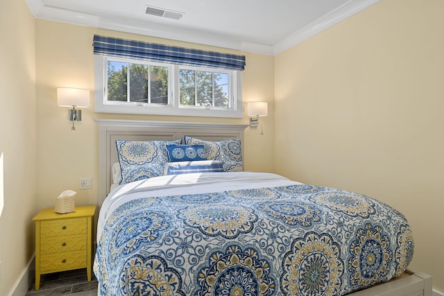 bedroom featuring visible vents, baseboards, and crown molding