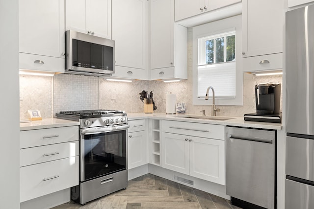 kitchen with visible vents, white cabinets, appliances with stainless steel finishes, and a sink