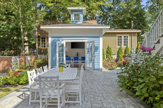 view of patio with outdoor dining space and fence