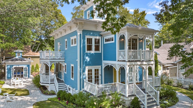 italianate home with a porch and fence