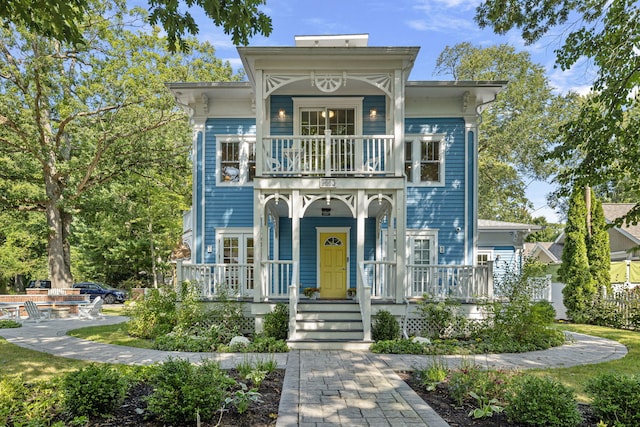 view of front of property with a balcony and covered porch