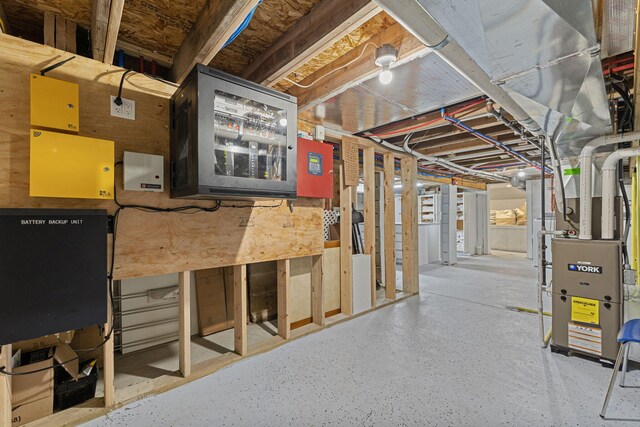 unfinished basement featuring heating unit