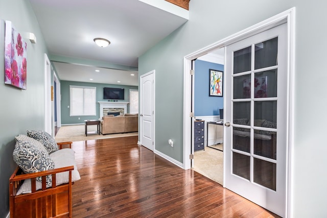 hall with baseboards, wood finished floors, and recessed lighting
