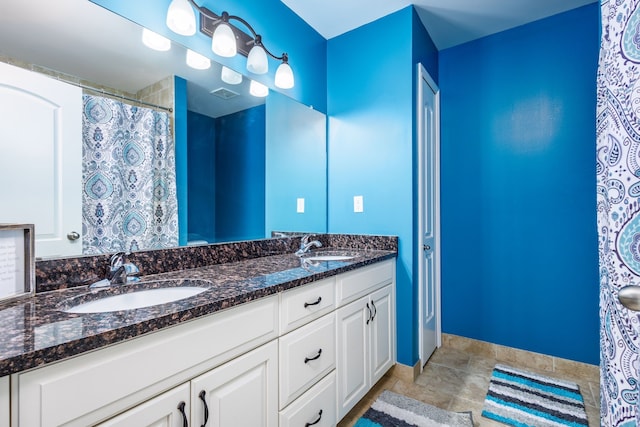 full bathroom with visible vents, a sink, and double vanity