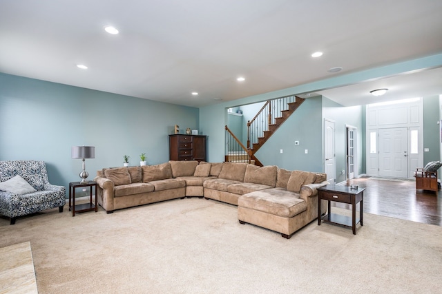 living room featuring recessed lighting, stairway, and carpet flooring