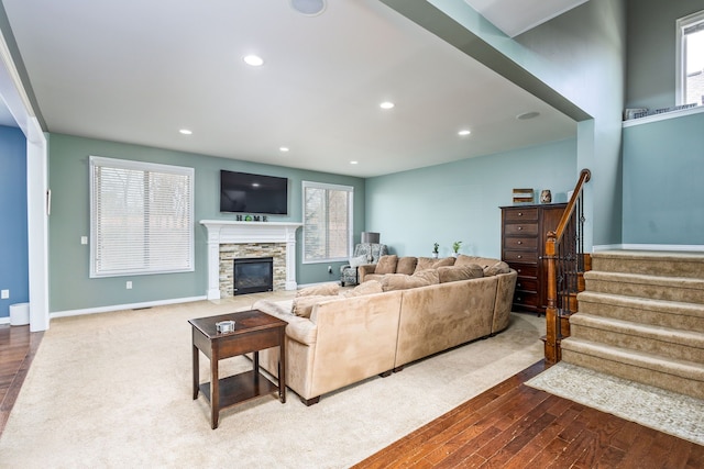 living room with recessed lighting, a fireplace, stairs, and dark wood-style flooring