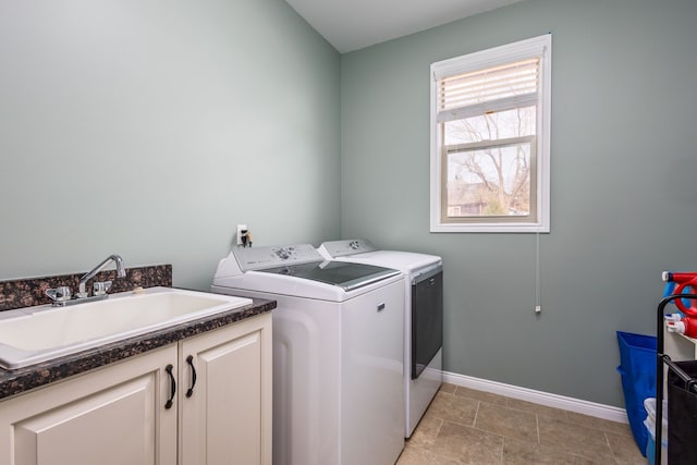 laundry room with washer and dryer, baseboards, cabinet space, and a sink