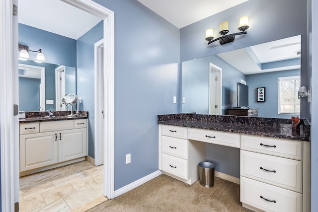 bathroom featuring baseboards and vanity