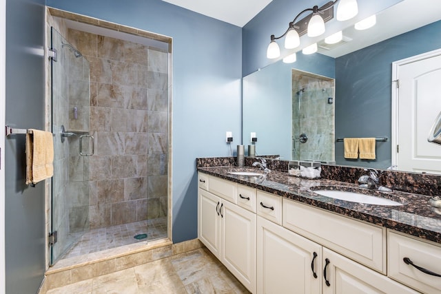 bathroom featuring a sink, double vanity, and a stall shower