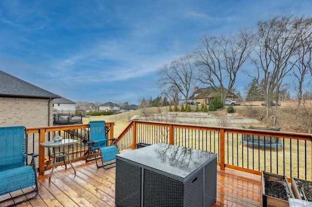 deck with outdoor dining area and a residential view