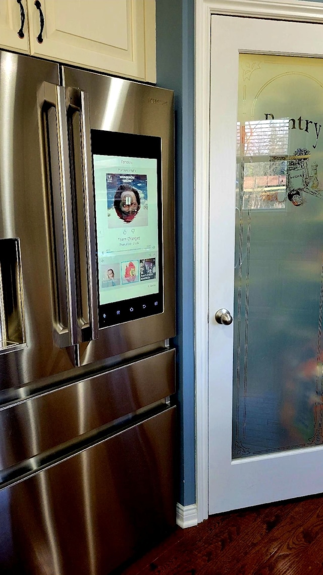 details with white cabinets and stainless steel fridge