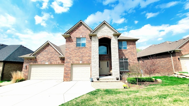 traditional-style house featuring driveway, brick siding, a front yard, and roof with shingles
