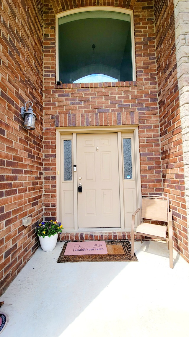 entrance to property with brick siding