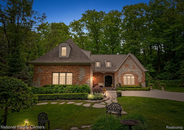 6654 College Park, Clarkston, MI 48346 - view of front of property with a front lawn, brick siding, and a shingled roof