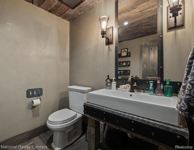 6654 College Park, Clarkston, MI 48346 - bathroom featuring toilet, vanity, wooden ceiling, wood finished floors, and baseboards